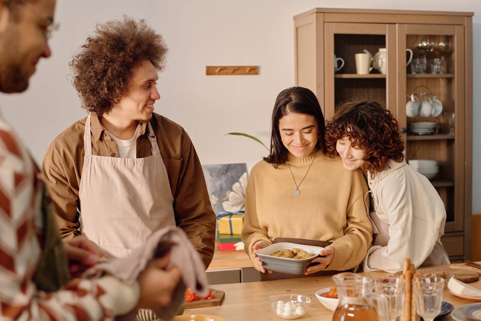 Small group cooking around a table