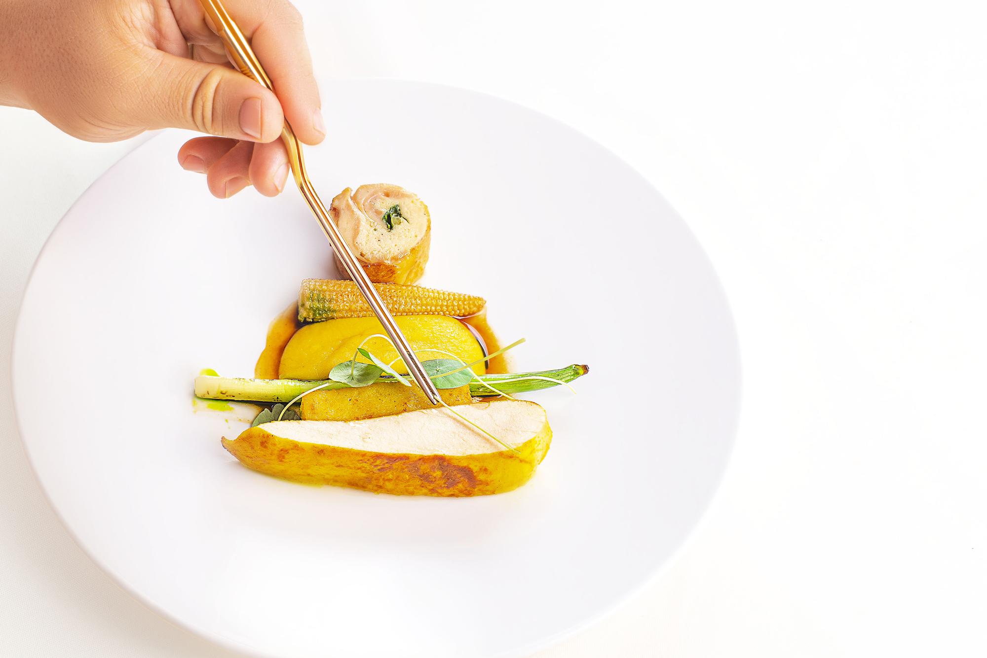 Instructor plating a warm seasonal dish